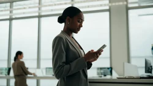 Einzelhandelsangestellte erhält digitale Gehaltsabrechnung per Smartphone im modernen Pausenraum